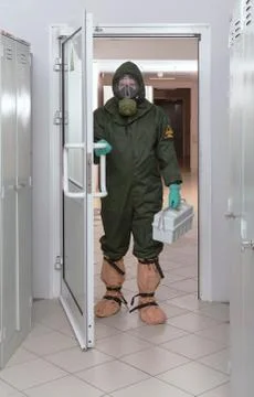 Men with box for transporting samplesin in biohazard protective suit Stock Photos