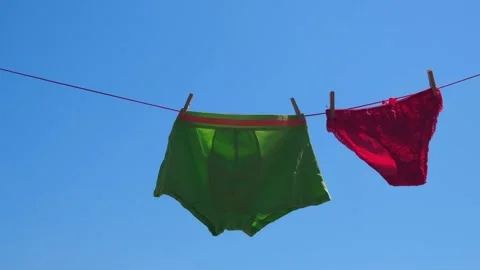 men boxers and women panties hang on rop, Stock Video