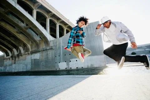 Men break dancing under overpass 스톡 사진