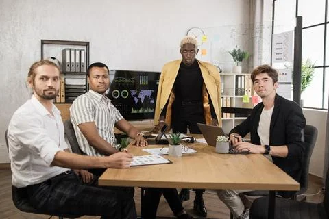 Men brokers spending their work for examining trade market. Stock Photos
