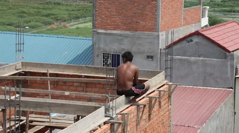 Men building brick house in poor village Cambodia Stock Footage 48017057