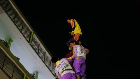Men building a human tower on dragon dance festival in Bangkok Stock Footage 101070327
