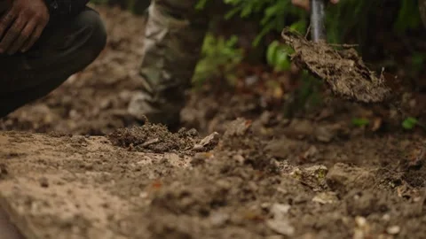 Men Burying Captive In The Pit After Interrogation IN The Forest. - closeup shot Vídeo Stock 328957107