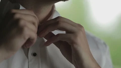 Men buttoning shirt collar Stock Footage 58007857