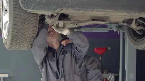 Men Checking Car Bottom Stock Footage 62166620