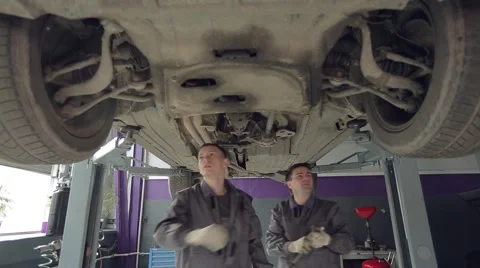 Men Checking Car Wheels and Bottom Stock Footage 62166781
