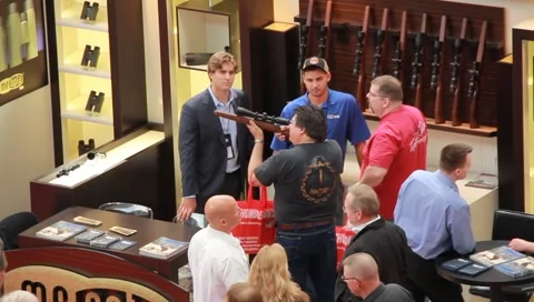 Men checking out scopes and pan of crowds at convention center(HD)c Video stock 4885562
