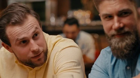 Men chilling with drinks in the pub Stock Footage 108308986