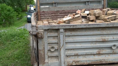 Men clean construction waste in the car Stock Footage 97630158