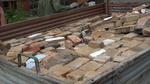 Men clean construction waste in the car Stock Footage 97630200