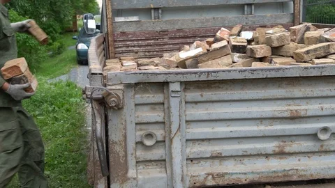 Men clean construction waste in the car Stock Footage 97630360