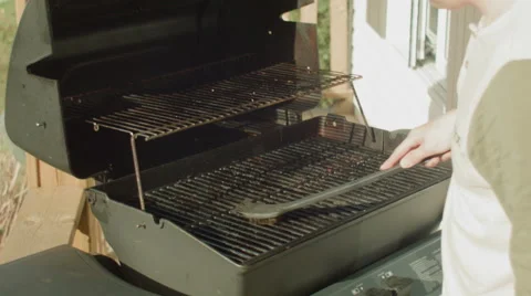 Men cleaning his propane bbq in summer 스톡 동영상 55155197