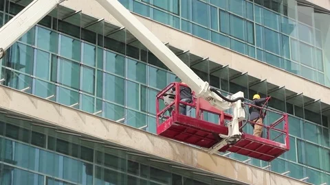 Men cleaning windows on skyscraper / office block Stock Footage 79695503