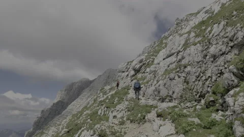 Men Climbing A Rocky Trail In The Alps Stock Footage 213636089