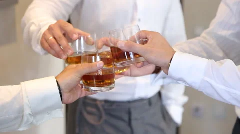 Men clinking whiskey glasses Stock Footage 56925850
