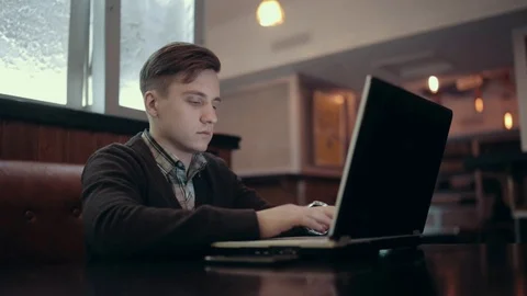 Men communicate in social networks sitting in front of a laptop in a bar Stock Footage 71565441