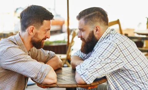 Men communicate with their views at the table Stock Photos