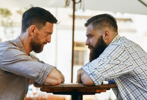 Men communicate with their views at the table Stock Photos