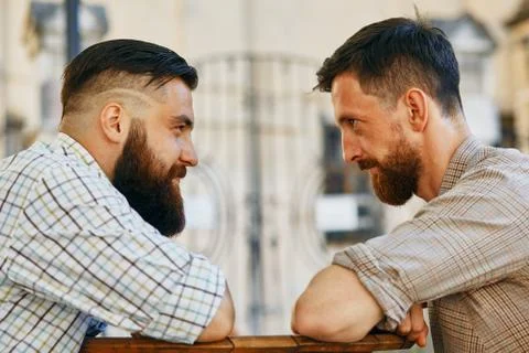 Men communicate with their views at the table Stock Photos