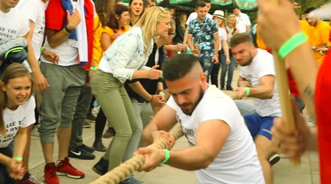 Men compete in a rope pulling" "Tug Of War" on sport games Stock Footage 67301300