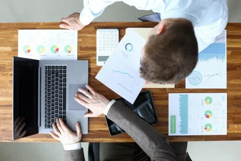 Men coordinate work on documents electronically Stock Photos