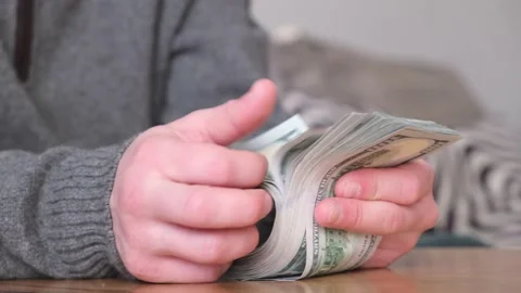 Men counting dollar cash. Counting money concept. 03.04.2022 Minsk, Belarus Stock Footage 174718043