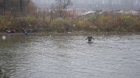 Men cross the river at the ford in long rubber boots, HD. 1920x1080 Stock Footage 71760864