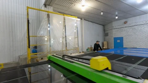 Men cut glass by CNC machine.Automatic glass cutting. Stock-Footage 125491513
