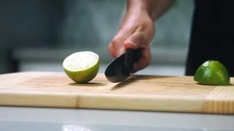Men cuts the lime slow motion Video stock 220280563