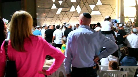 Men dance with Bible scrolls during the ceremony of Simhath Torah.  Slow motion Stock Footage 56001560