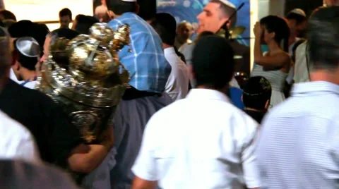 Men dance with Bible scrolls during the ceremony of Simhath Torah. Tel Aviv Stock Footage 56001619