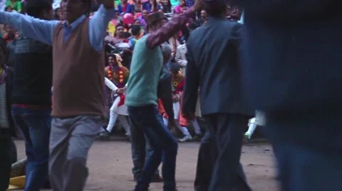 Men dance in the center of a line of men during a Hindu festival. Stock Footage 66525004