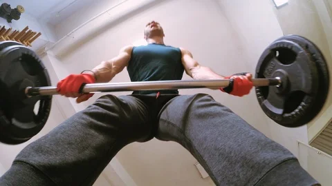 Men deadlifting weights in gym Stock Footage 107919928