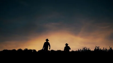 Men in desert at sunset Stock Footage 76832701