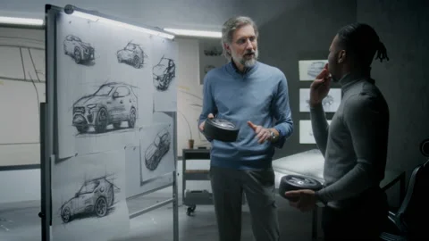Men developing electric car sketch together Stock Footage 220905255