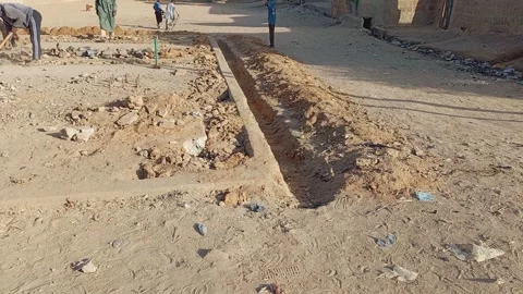 Men Digging a Concrete Field Kano Nigeria 動画素材 325949120