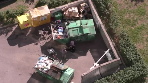 Men digging in a garbage can in russia Stock Footage 244794177