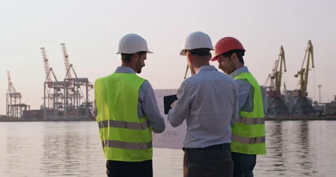 Men discuss construction issues with delineation and tablet Stockbeeldmateriaal 166271131