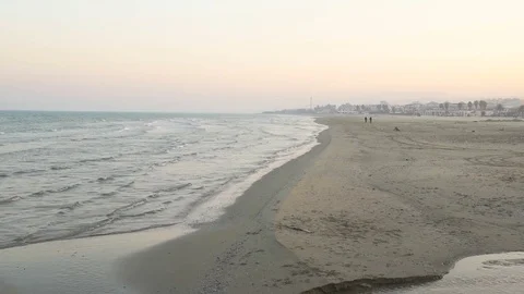 Men in the distance on the beach 스톡 동영상 73288055