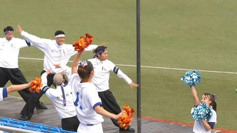 Men doing their stunts on the sidelines in Meiji Jingu Baseball Stadium in To Stock Footage 125778301