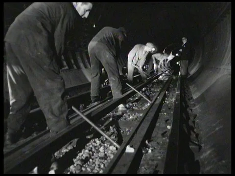 Men doing track reconditioning at night in London Underground tunnel, UK 1958 Video stock 136677252