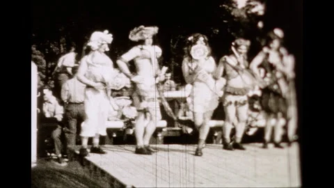 Men in Drag Performing at Outdoor Event in Post-War Germany - Archival Stock Footage 332269099