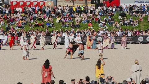 Men dressed as gladiators performe fight at Circus Maximus Stock Footage 97403410