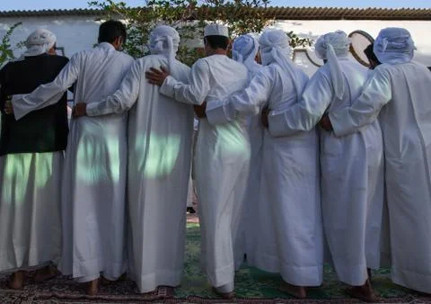Men dressed in white dancing during a wedding ceremony, Hormozgan, Bandar-e Stock Photos