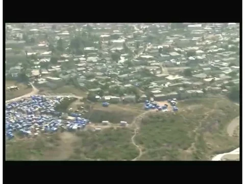 Men drill and load dynamite into the drilled rock where they wire it together 動画素材 75413767