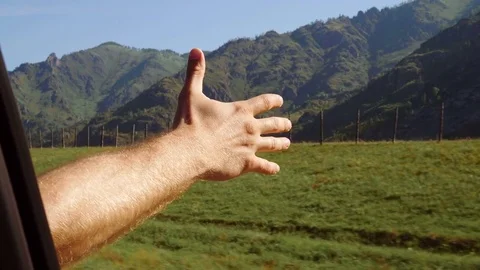 Men driver feeling the wind through her hands while driving in the country side. Stock Footage 81232672
