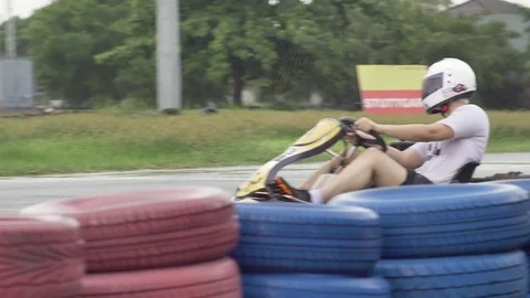 Men driving Go-kart car with speed in a racing track. Karting in the rain. Slow Stock Footage