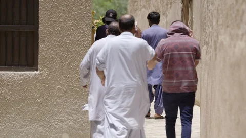 Men in Dubai walk to Mosque Stock Footage 125878110