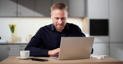 Men Engaging In Virtual Training Session On Laptop In Kitchen Stock Photos