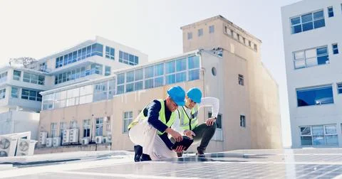 Men, engineer and team for solar energy with tablet on roof, discussion or 写真素材